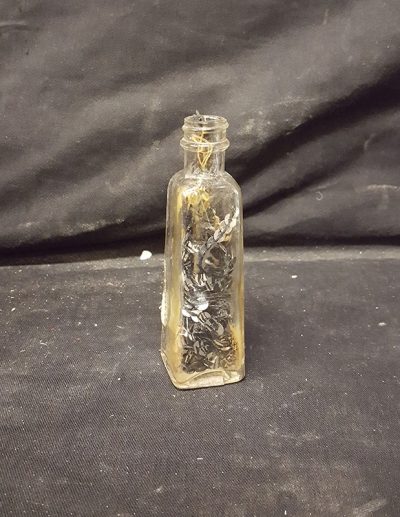 Vial full of Sequence sewn to string