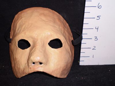 Flesh colored, wrinkled half mask
