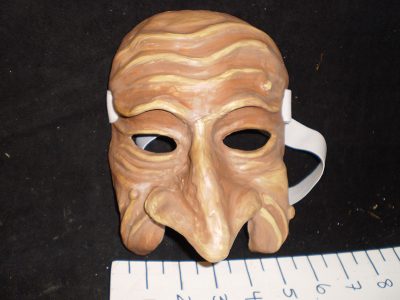 Dark / flesh colored mask with curved nose