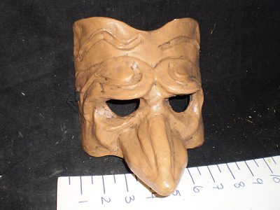 Dark brown mask with pointed nose