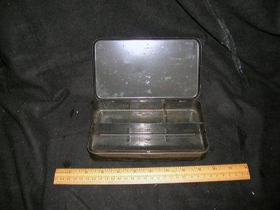 Black tin with “Assorted Spoons” Etched on Lid