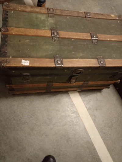 Green suitcase looks like travel (chest)