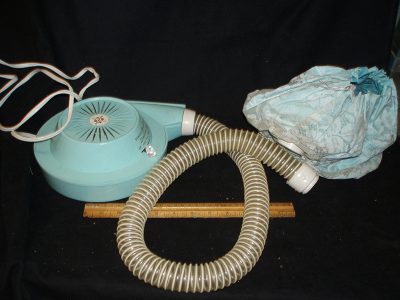 Portable hair dryer in beige case