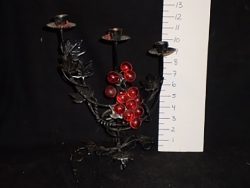 Wrought iron candlestick with plastic red grapes