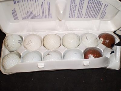Golf balls, in egg carton